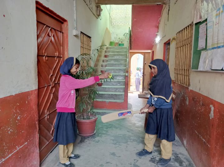 young girls playing cricket