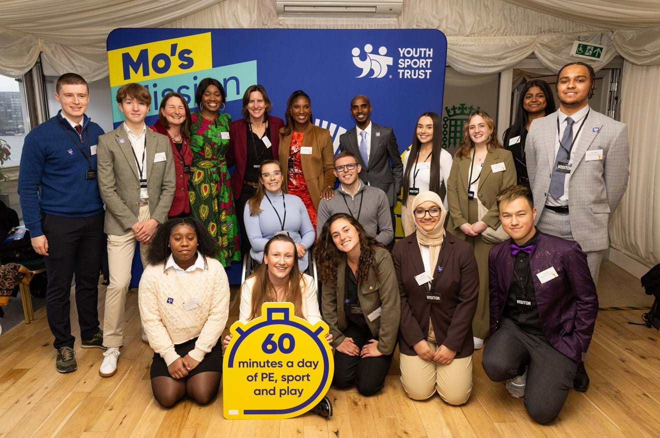 Youth Board and athletes in front of a banner saying Mo's Mission at manifesto launch in Parliament.